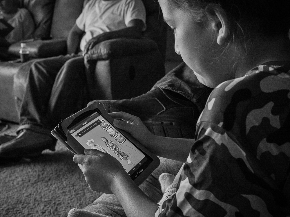 Luke Brien Uses an App to Learn His Crow Language, Arlee, Flathead Reservation, Montana, 2016 by Sue Reynolds
