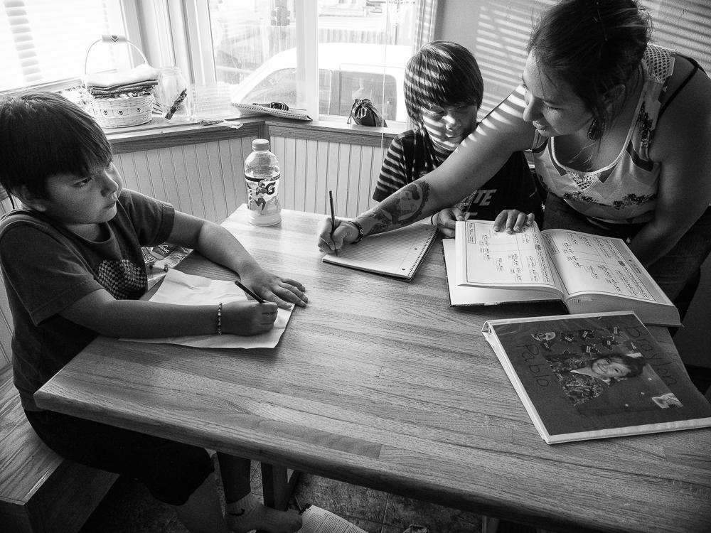 Nicole Pablo Helping Her Sons with Homework, Flathead Reservation, Montana, 2016 by Sue Reynolds